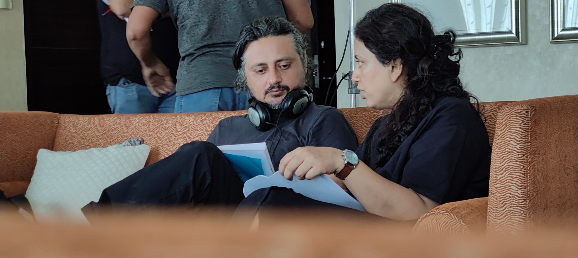 Amardeep Galsin and Amir Rizvi reviewing a script on set